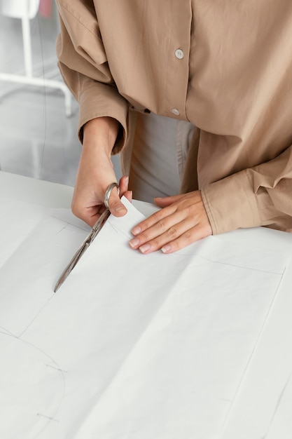 Free photo fashion designer working in her workshop alone