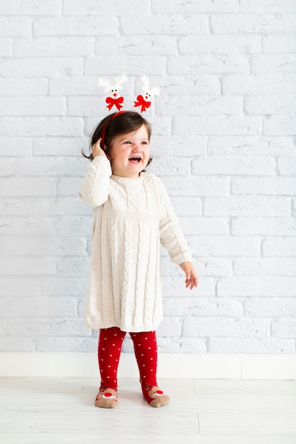 Free photo fashion dressed smiling little girl