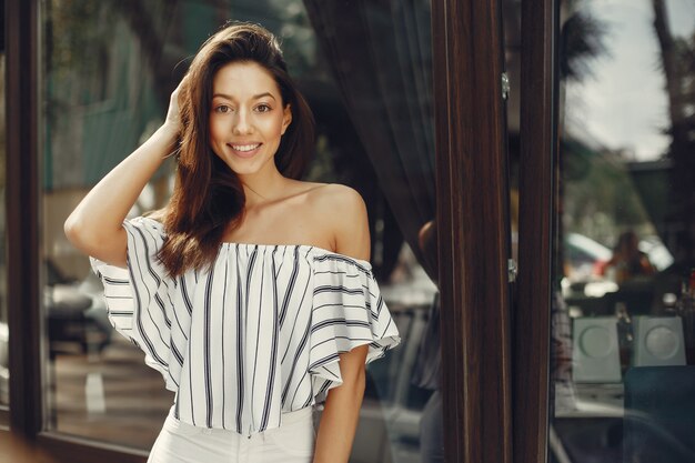 Fashion girl standing in a summer city