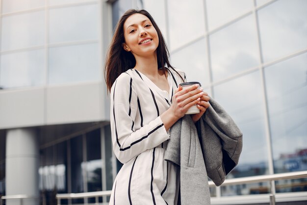 Fashion girl standing in a summer city