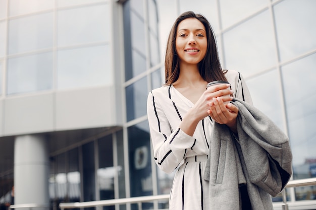 Fashion girl standing in a summer city