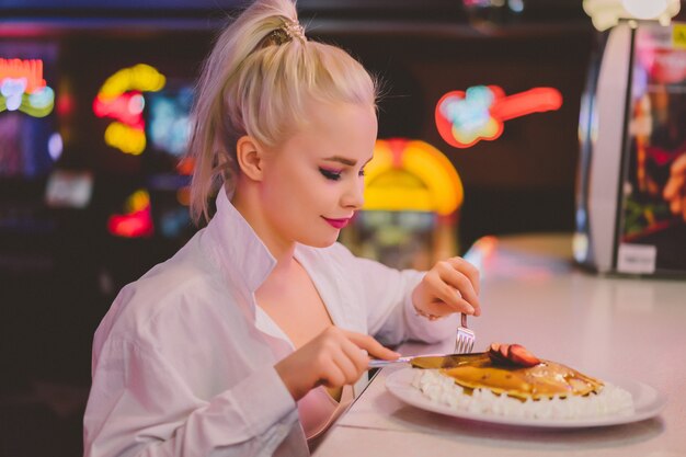 Fashion girl in a vintage cafe in the style of pin-up.