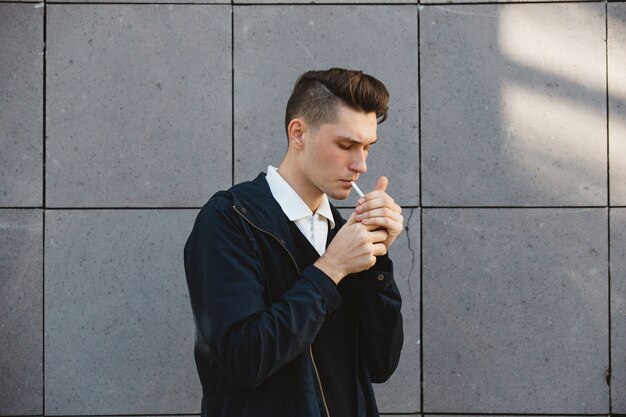 Fashion hipster male model smoking