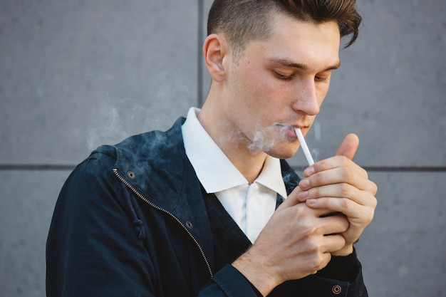 Fashion hipster male model smoking