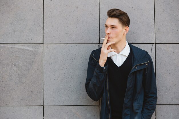 Fashion hipster male model smoking