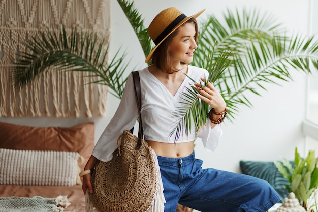 Fashion image of stylish brunette woman posing at home in boho style