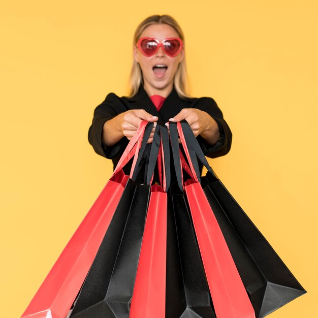 Fashion lady wearing black and heart shaped glasses front view