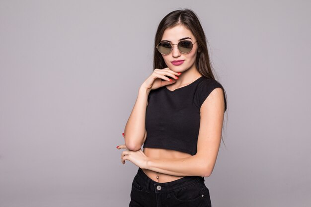 Fashion lifestyle portrait woman sunglasses on grey wall