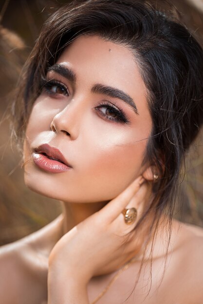 Fashion model in bronze summer makeup and smokey eyes