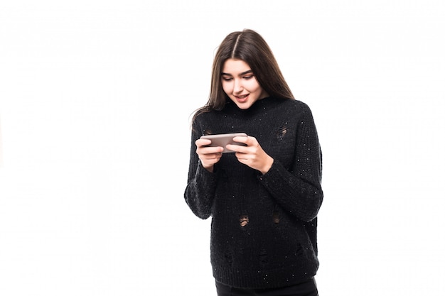 Fashion model in dark sweater with phone on white in studio