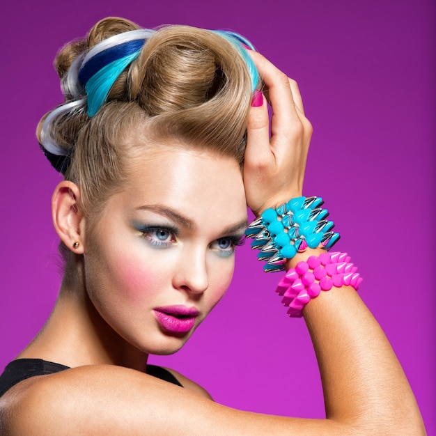 Fashion model with bright makeup and creative hairstyle Woman with  Fashion makeup Closeup portrait