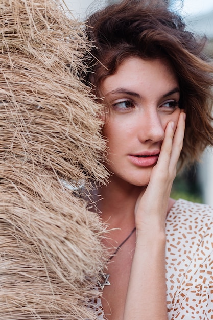 Fashion outdoor portrait of brunette short hair woman with broom