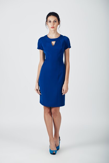 파란 드레스에 아름 다운 젊은 여자의 패션 사진.