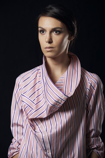 Fashion photo of young magnificent woman in pink shirt