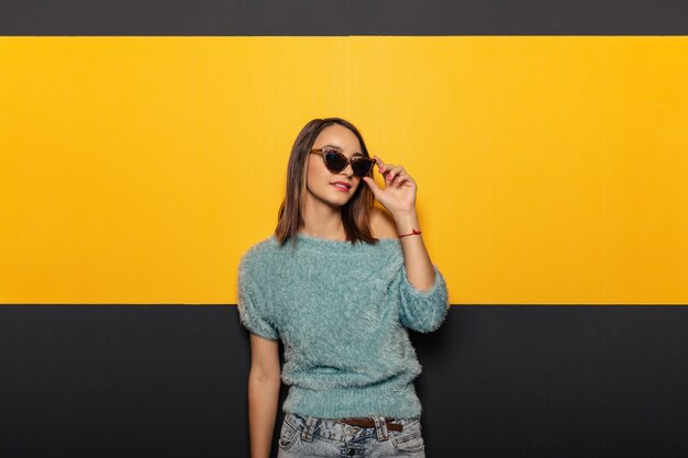 Fashion portrait of an appealing, stylish woman with sunglasses