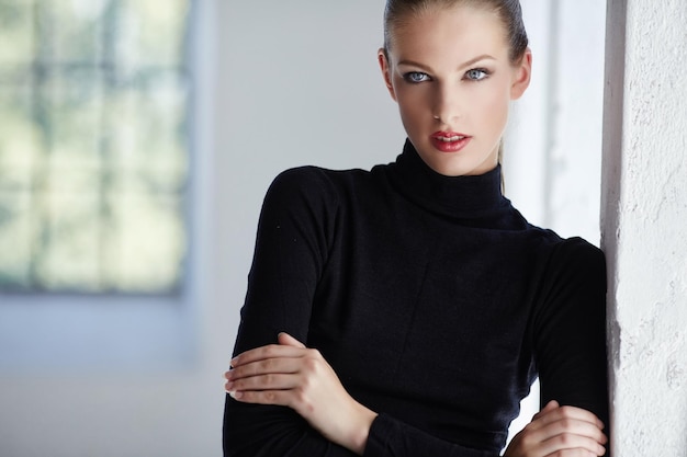 Fashion portrait of brunette woman in black dress.