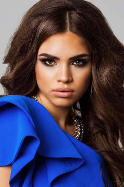 Fashion portrait of elegant woman with magnificent hair. Brunette girl. Perfect make-up