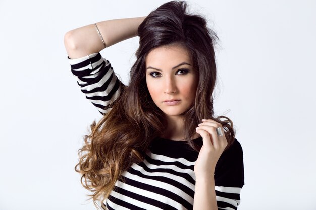 Fashion portrait of pretty young woman posing in the studio photo.