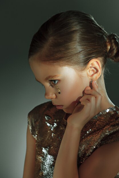 The fashion portrait of young beautiful preteen girl at studio
