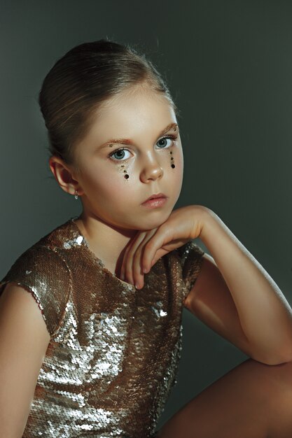 The fashion portrait of young beautiful teen girl at studio