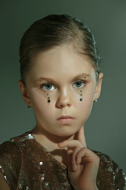 The fashion portrait of young beautiful teen girl at studio