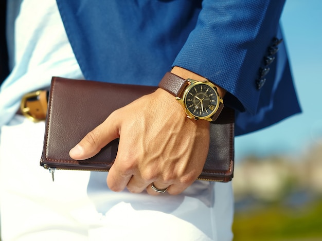 Fashion portrait of young businessman handsome model man in casual cloth suit with accessories on hands