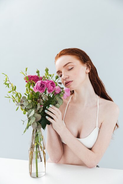 Fashion portrait of a young redheaded girl with eyes closed