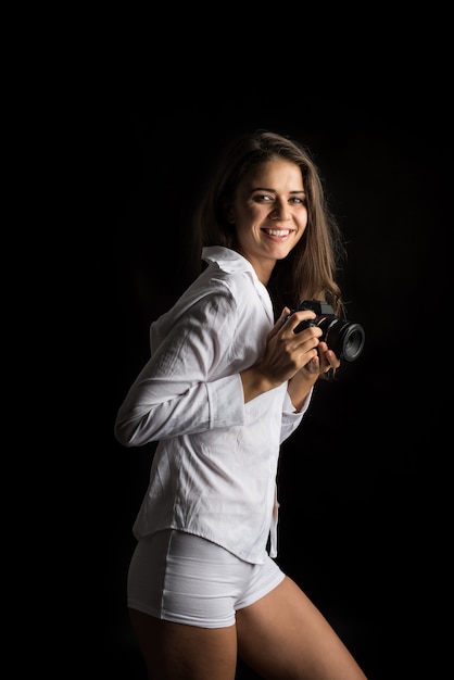 Fashion Portrait of young Woman photographer with camera