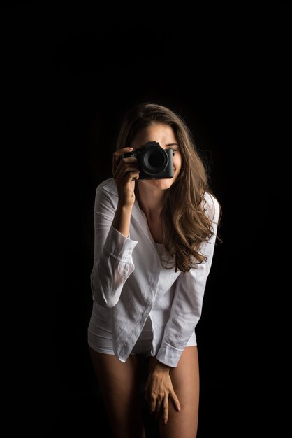 Fashion Portrait of young Woman photographer with camera