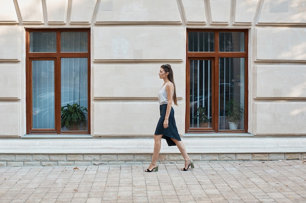 Fashion pretty woman walking through the streets of Old City