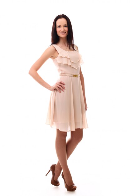 Fashion woman posing with dress in pastel pink color, isolated