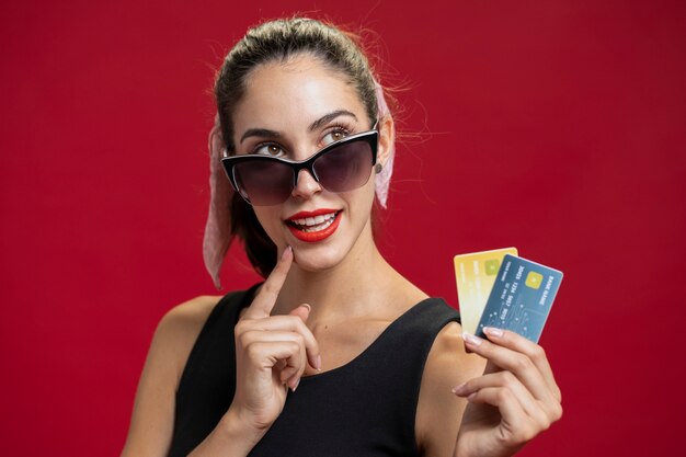 Fashion woman showing her credit cards close-up
