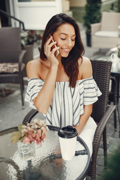 Fashion young girl in a summer cafe