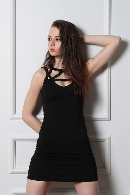 Fashion young woman posing with black dress