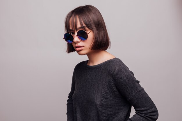 Fashion young woman in sunglasses isolated.