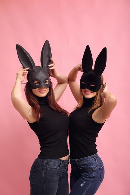 Fashion young women posing with black rabbit mask