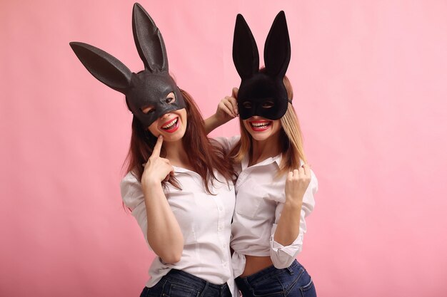 Fashion young women posing with black rabbit mask