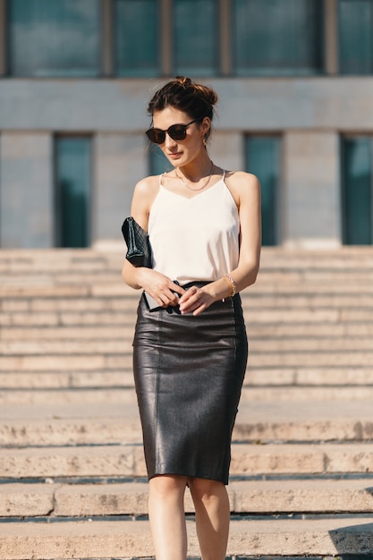 Free photo fashionable brunette businesswoman in leather pencil skirt and s