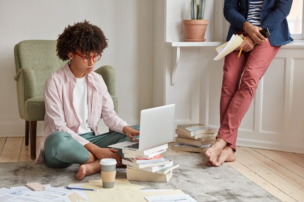 Fashionable business leader drinks hot tea bare foot