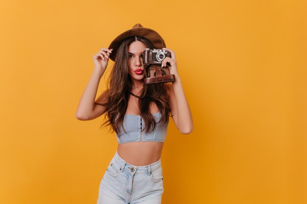 Fashionable female photographer posing with kissing face expression