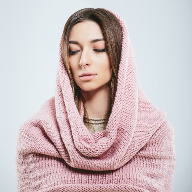 Fashionable girl in winter knitted clothes