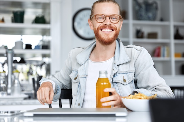 Fashionable hipster guy dressed in denim shirt and wearing stylish glasses