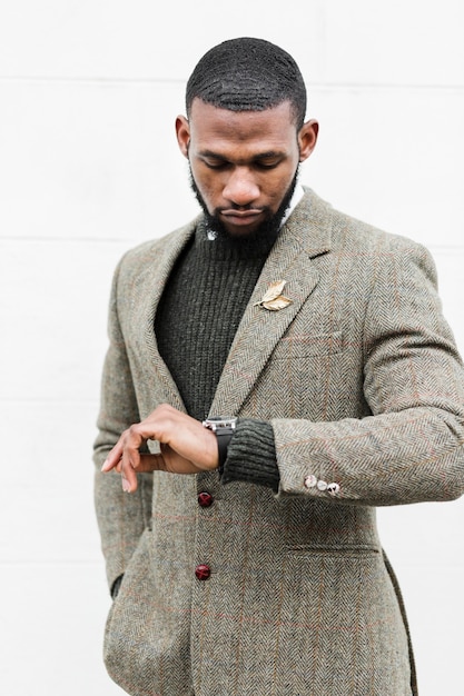 Fashionable man looking at his watch