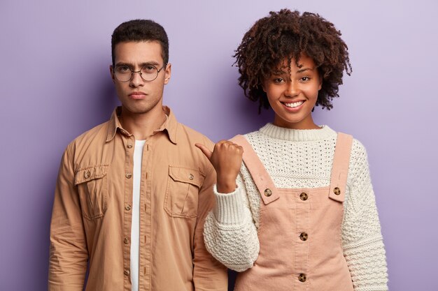 Fashionable man and woman posing together