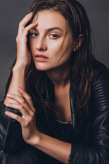 Fashionable model posing in studio in stylish outfit rock leather style trend