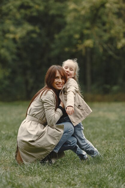 Fashionable mother with daughter. People walks outside