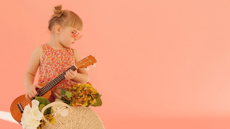 Free Photo fashionable toddler holding guitar
