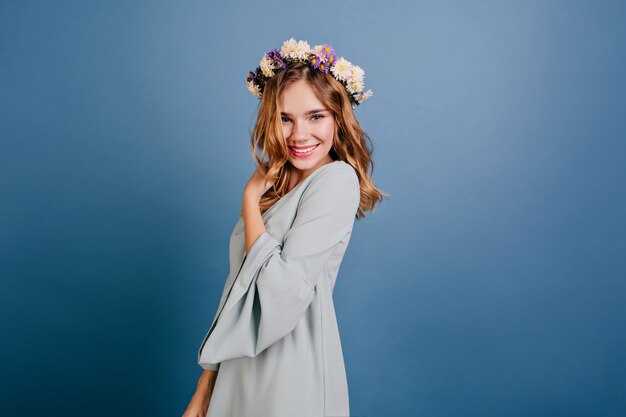 Fashionable white woman in light-blue outfit having fun in studio