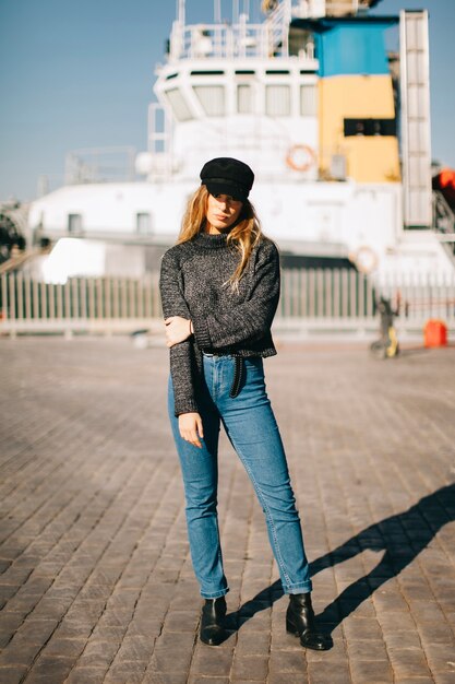 Fashionable woman in front of ship