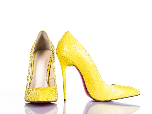 Free photo fashionable woman's high heel shoe isolated on white background. beautiful yellow female high heels shoe. luxury.